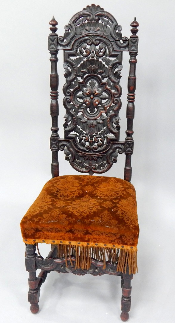 Appraisal: A thC style oak hall chair with pierced and carved