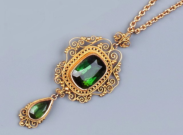 Appraisal: A GREEN TOURMALINE PENDANT the central cushion-shaped tourmaline within bead