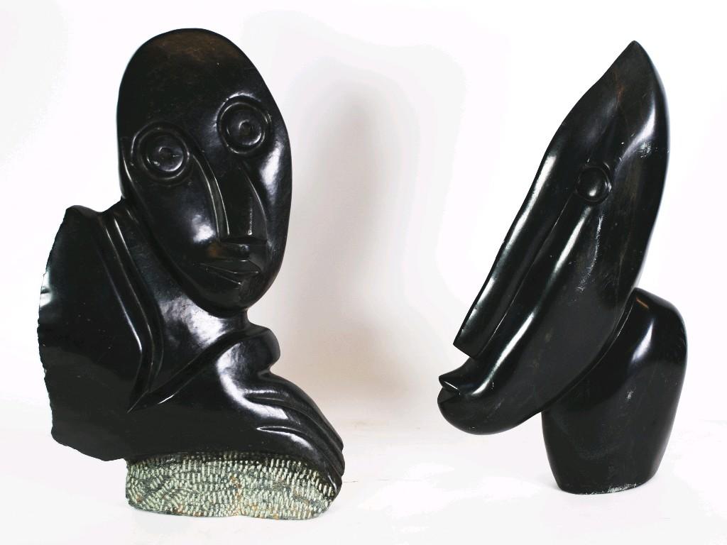 Appraisal: TWO CARVED AND POLISHED BLACK SLATE STYLISED HEADS one signed