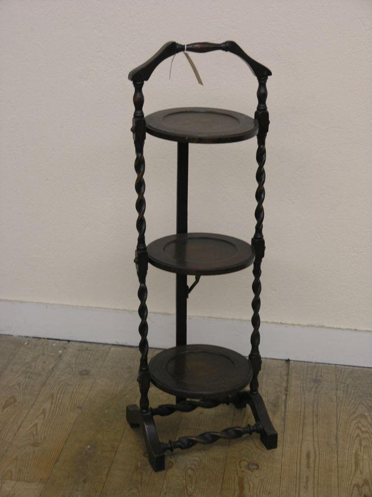 Appraisal: A solid dark oak three tier folding cake stand barley