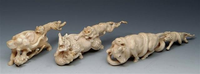 Appraisal: A JAPANESE CARVED IVORY MODEL of two tigers attacking an