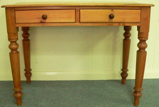 Appraisal: A rectangular pine table fitted two drawers on turned legs