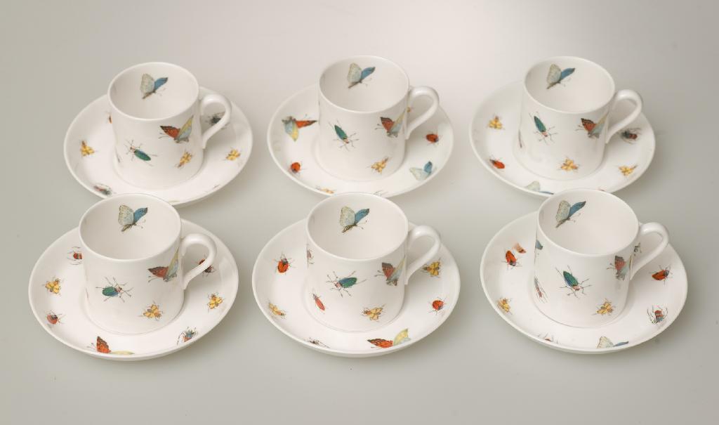 Appraisal: EXTENSIVE SET OF TWENTY COFFEE CANS AND SAUCERS decorated with