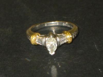 Appraisal: A DIAMOND RING the central marquise cut flanked by baguette