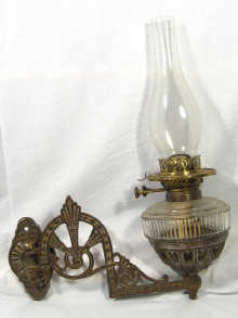 Appraisal: A glass and brass oil lamp on its original hinged