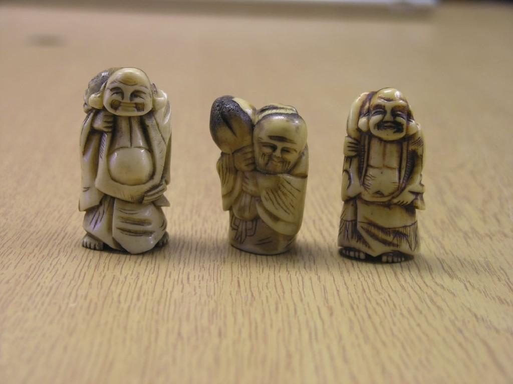 Appraisal: Three Japanese carved ivory figural netsuke