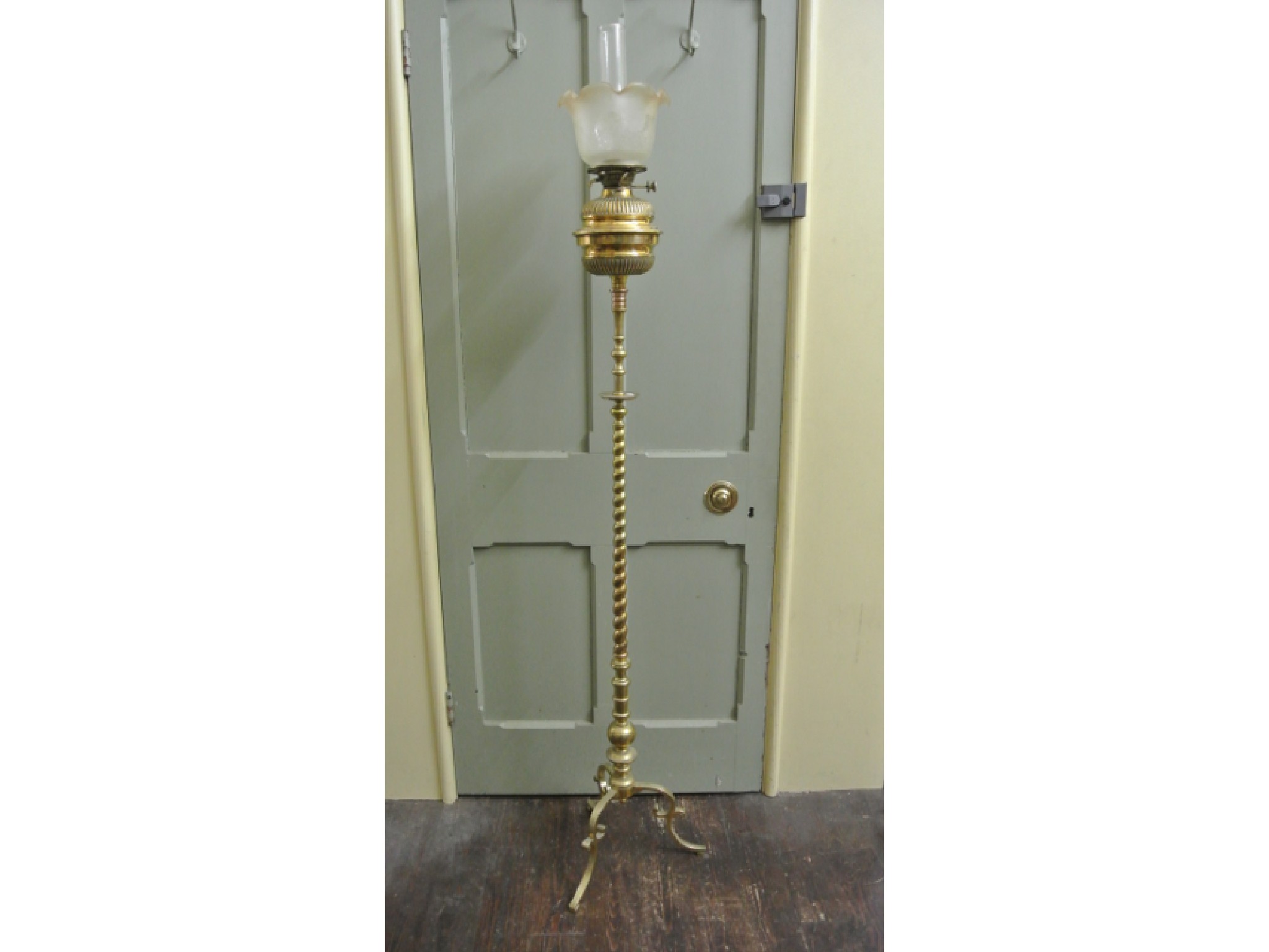 Appraisal: A polished brass oil lamp standard with partial rope twist