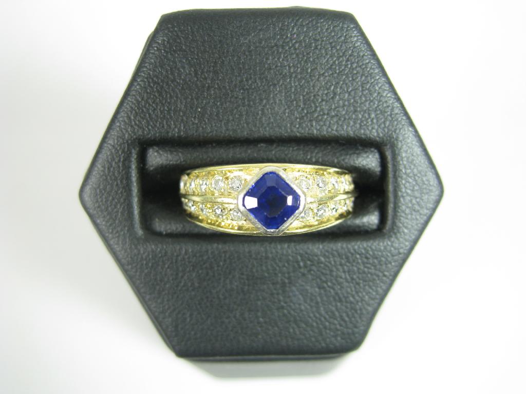 Appraisal: A Sapphire and Diamond Ring the central step-cut sapphire collet-set