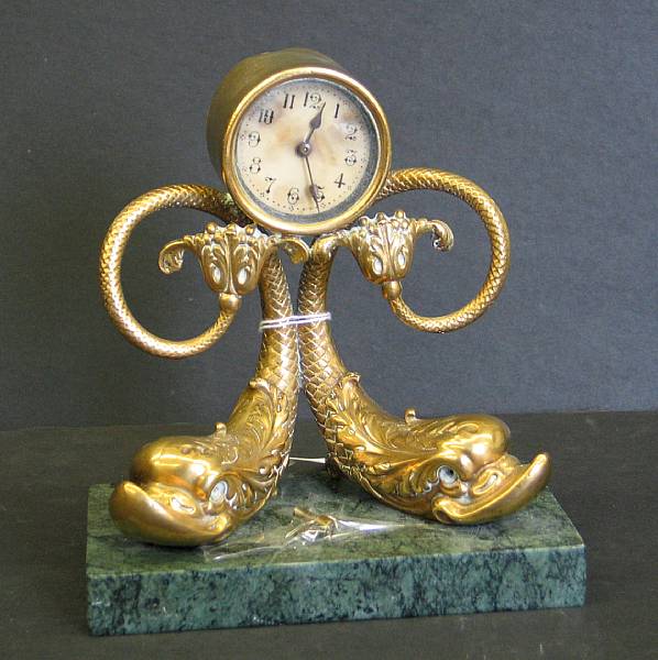 Appraisal: A Neoclassical style bronze and marble dolphin form table clock