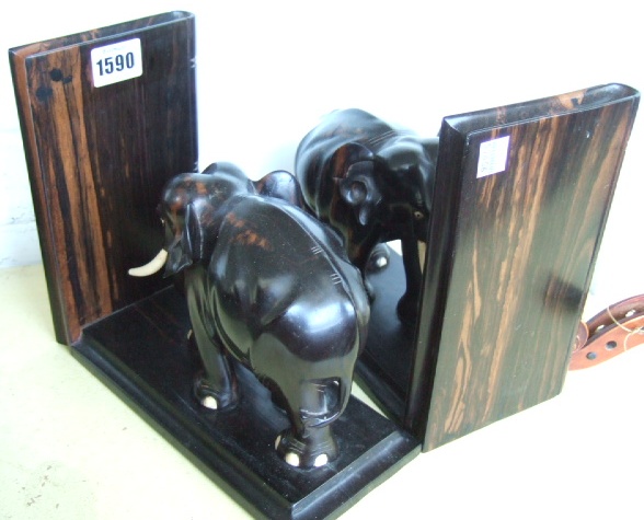 Appraisal: A pair of carved ornamental book ends modelled as elephants