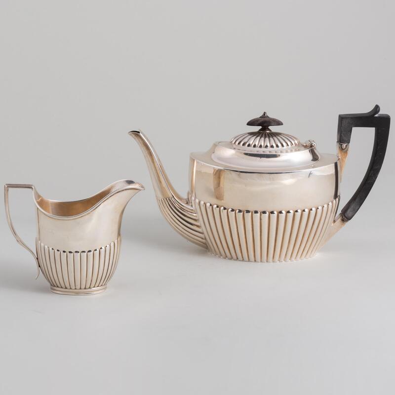 Appraisal: Victorian Silver Teapot and a Cream Jug The teapot with