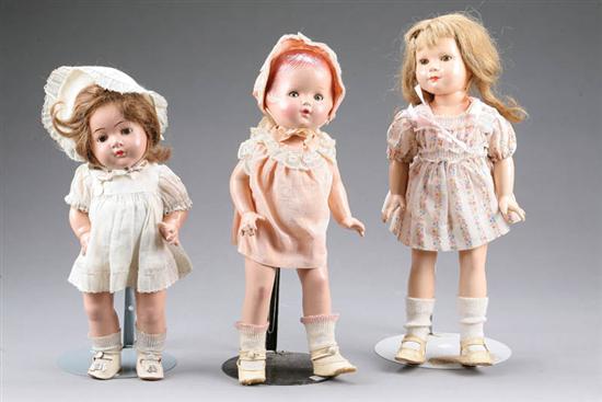 Appraisal: THREE DOLLS Composition girl with sleep eyes and molded hair