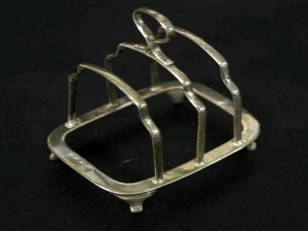 Appraisal: Small s silver toast rack maker TB S Sheffield wide