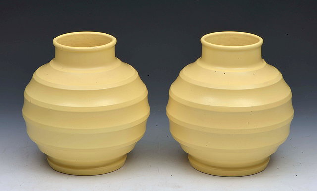 Appraisal: Keith Murray for WedgwoodPair of 'Football' vases in matt cream