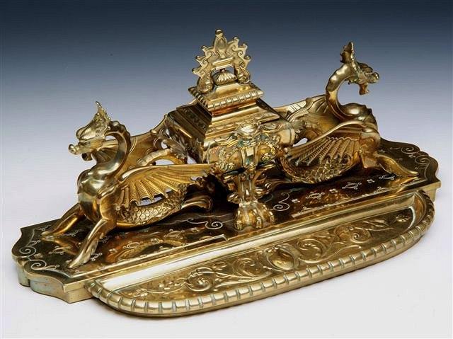 Appraisal: A LARGE FRENCH BRASS INKWELL with dragon supports and mask