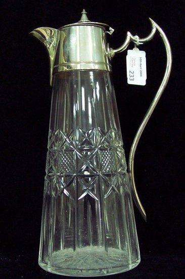 Appraisal: A claret jug of cut glass with plated mounts handle