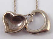 Appraisal: Two stylised silver heart pendants and chain all by Tiffany