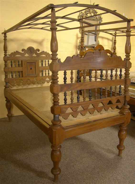 Appraisal: SRI LANKAN COLONIAL SOLID SATINWOOD CANOPY BED the headboard with