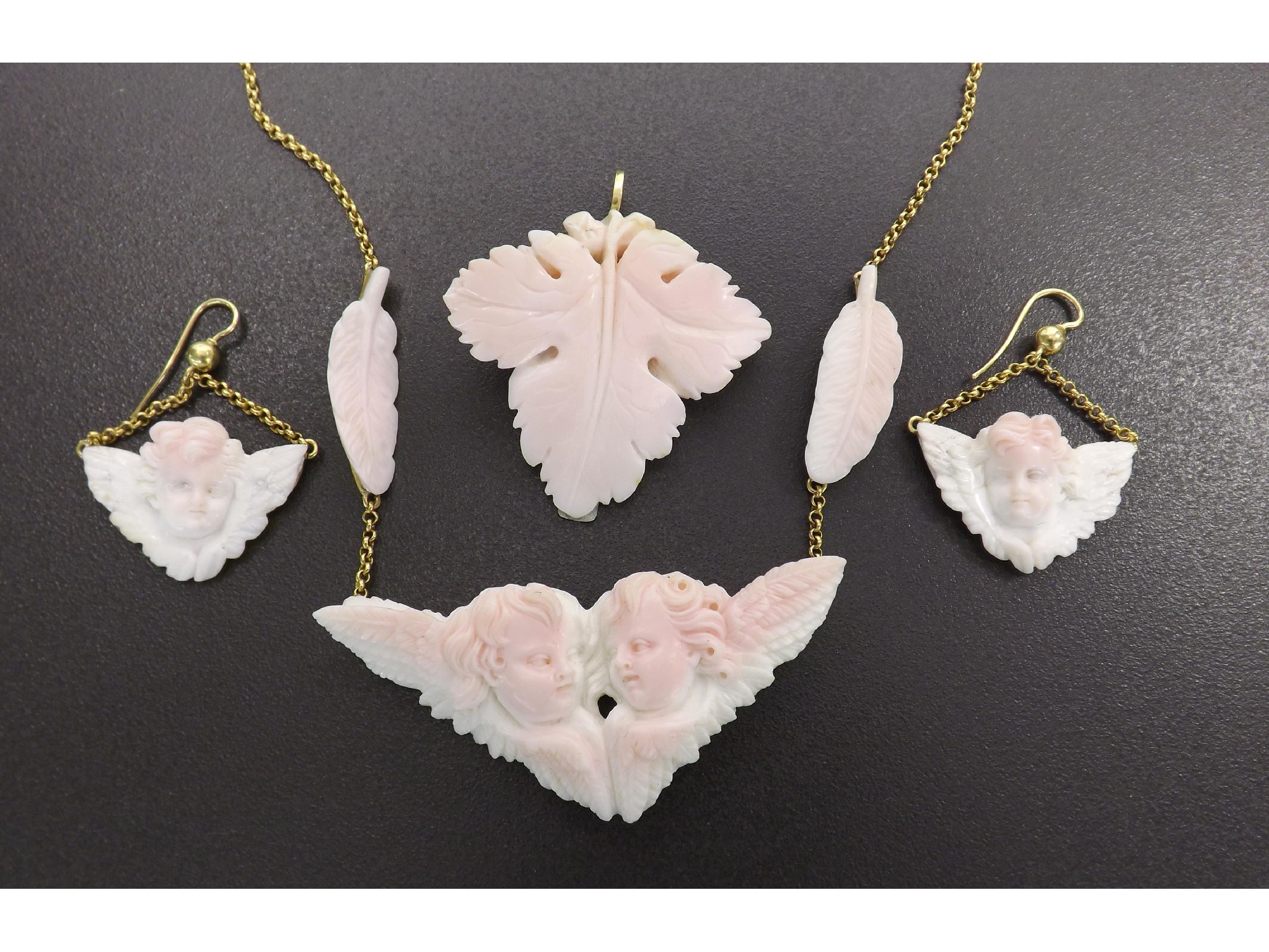 Appraisal: Pink coral suite comprising a pendant and a pair of