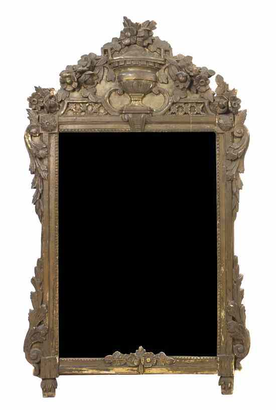 Appraisal: A Continental Giltwood Mirror having an urn form finial issuing