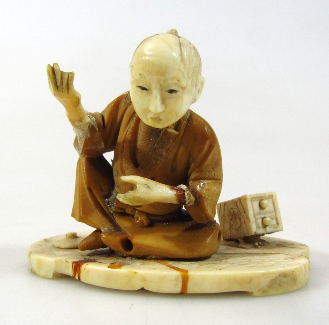 Appraisal: A thC Japanese ivory figure group of a gentleman in