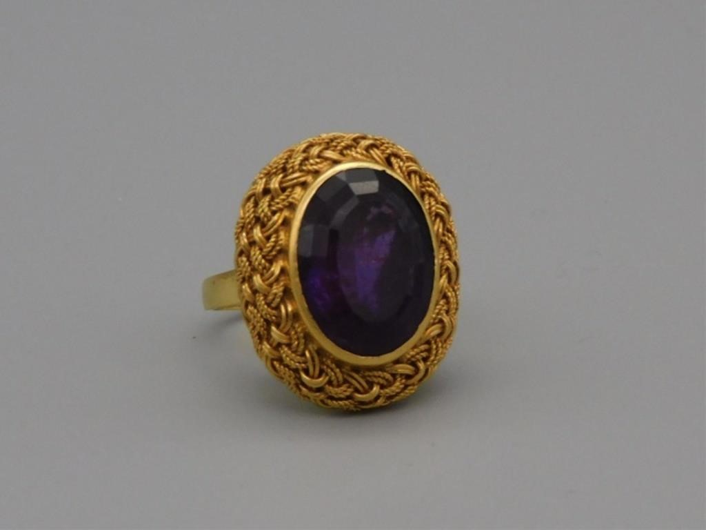 Appraisal: KT GOLD LADY'S RING BASKET WEAVE DESIGN WITHoval faceted amethyst