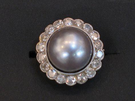 Appraisal: A PEARL AND DIAMOND CLUSTER RING the large half grey