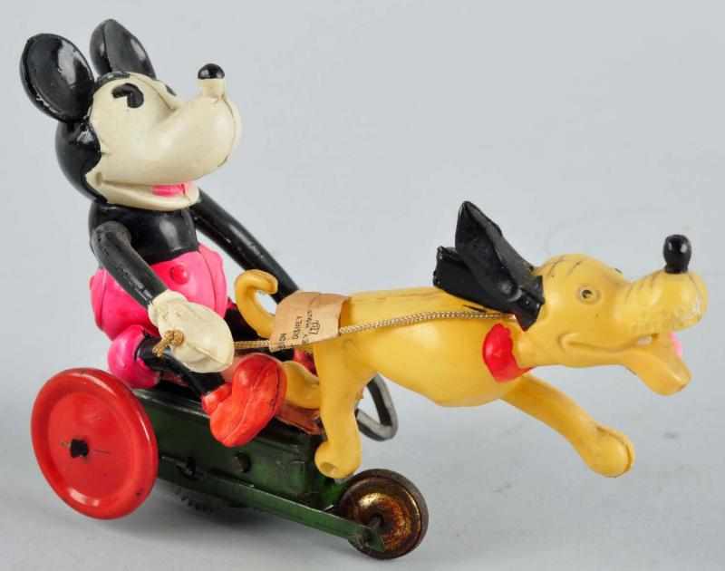 Appraisal: Celluloid Mickey in Cart Pulled by Pluto Toy Description Japanese