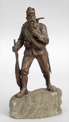 Appraisal: BRONZE-PATINATED METAL FIGURE OF A HIKER Modeled walking holding a