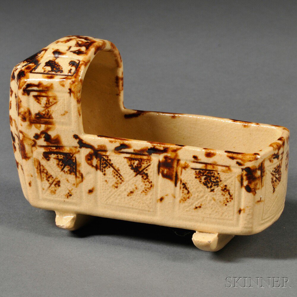 Appraisal: Staffordshire Cream-colored Earthenware Cradle England c press-molded paneled body sponge