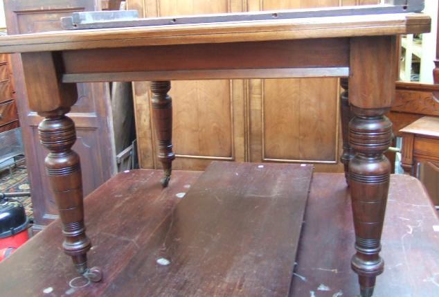 Appraisal: An Edwardian stained beech extending dining table the canted top