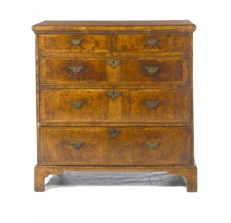 Appraisal: A WALNUT CHEST OF DRAWERS with banded top and sides