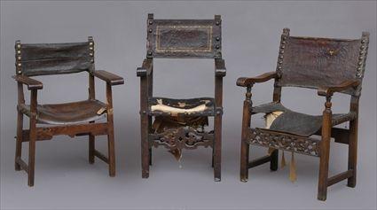 Appraisal: THREE ITALIAN BAROQUE WALNUT ARMCHAIRS With brass nail-headed leather backs