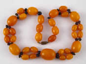 Appraisal: An amber bead necklace largest bead approx mm long necklace