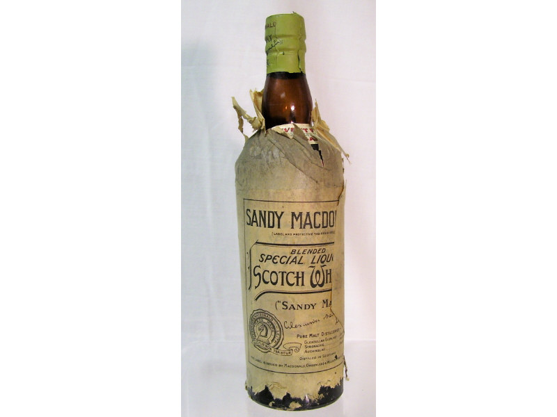 Appraisal: Sandy Macdonald Scotch Whisky bottle Sealed bottle with paper wrapper