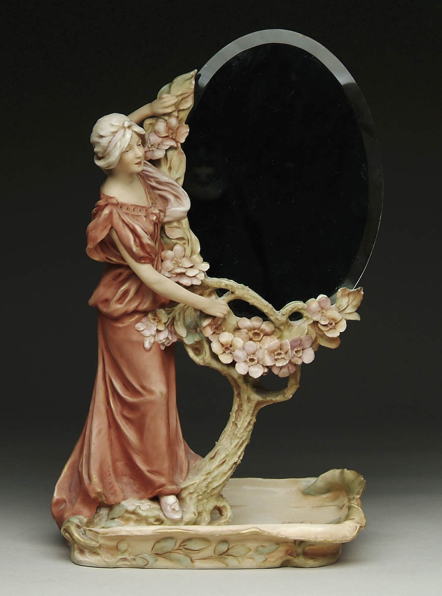 Appraisal: ROYAL DUX FIGURAL MIRROR Mirror stand has a young maiden