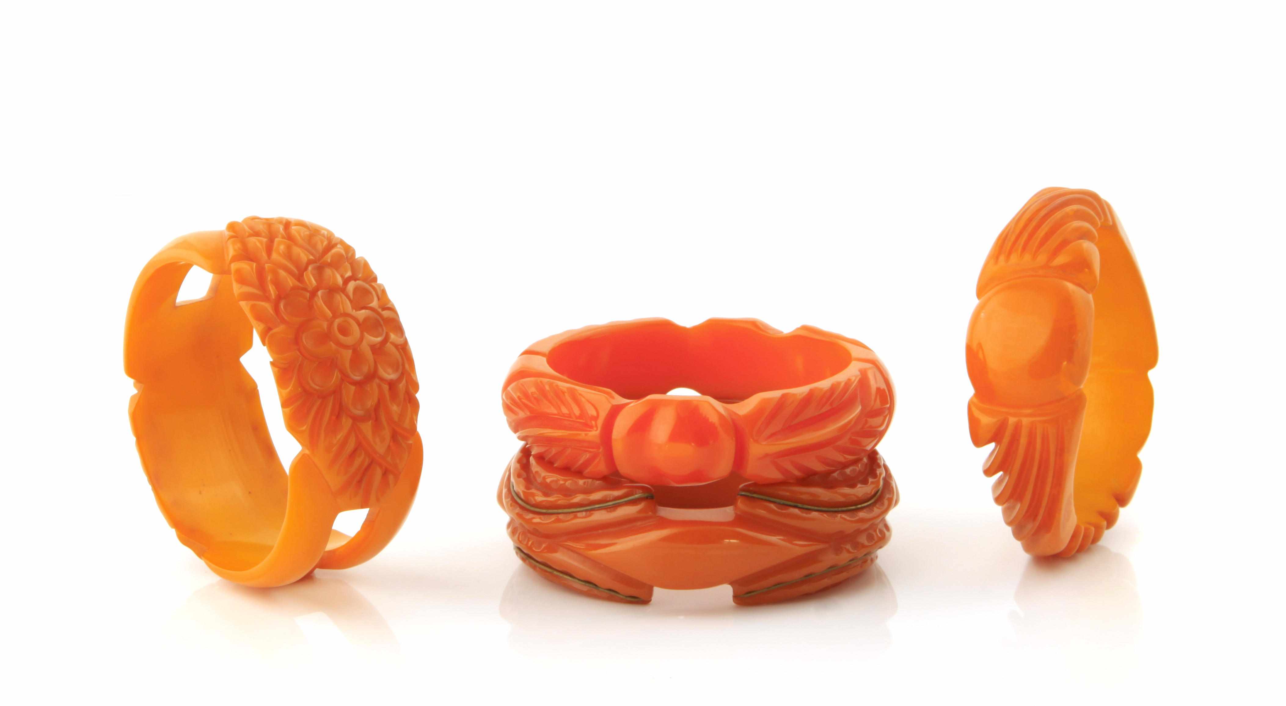 Appraisal: Four deeply carved butterscotch Bakelite bangle bracelets each diameter in