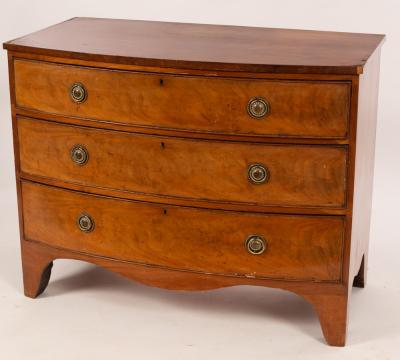 Appraisal: A Regency mahogany bowfront chest of three long graduated drawers