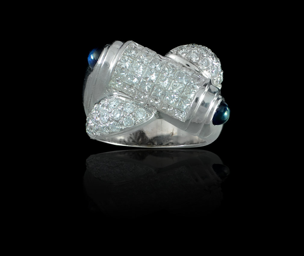 Appraisal: DIAMOND AND SAPPHIRE BY-PASS RING K white gold ring of