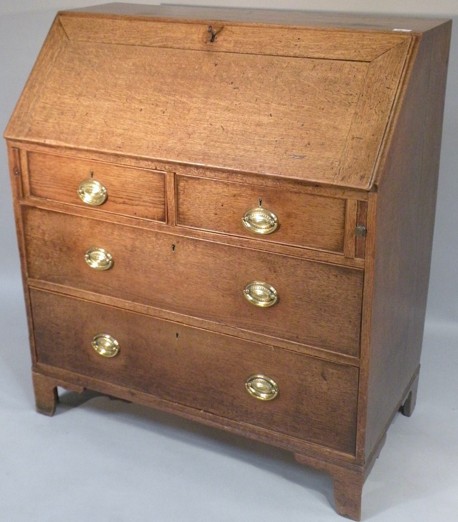 Appraisal: An early thC oak bureau the fall front revealing a