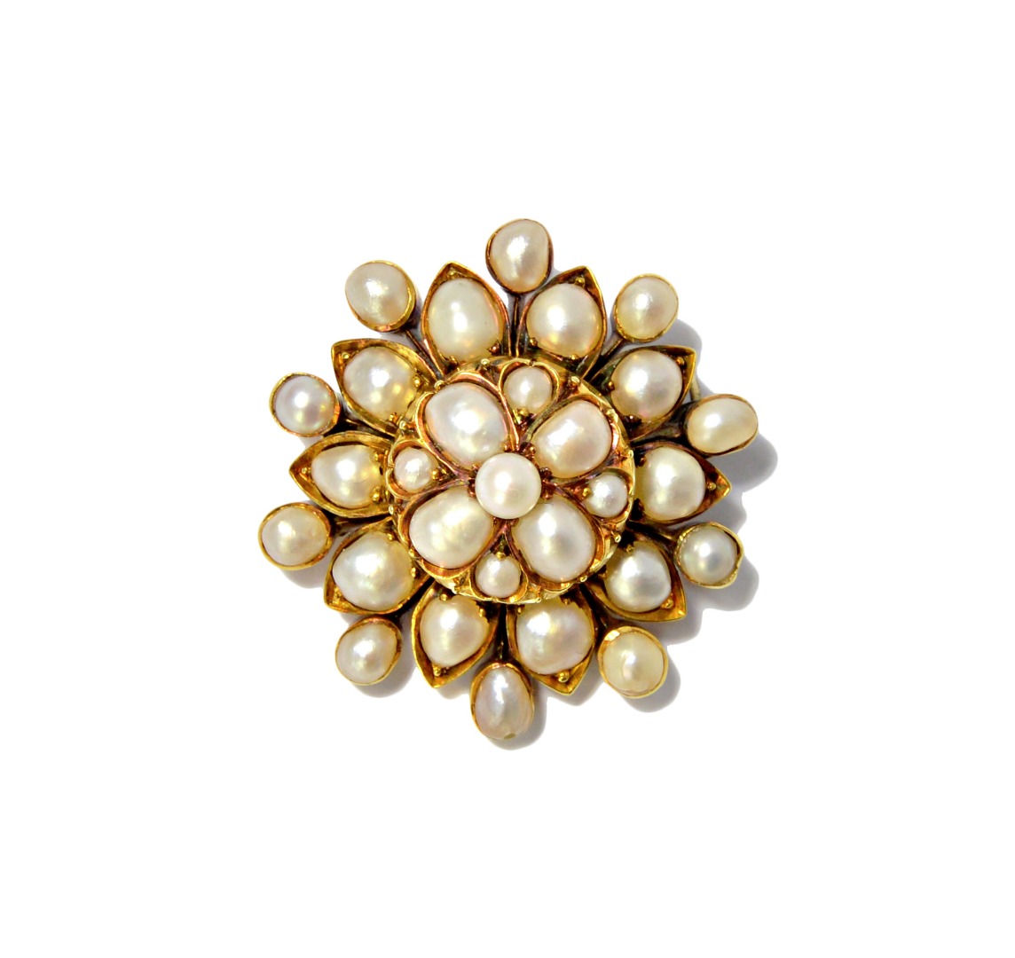 Appraisal: A gold and half pearl set brooch in a shaped