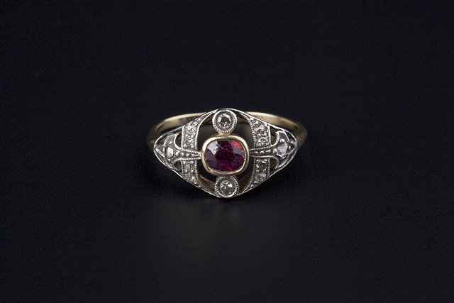 Appraisal: A RUBY AND DIAMOND PANEL RING the oval mixed-cut ruby