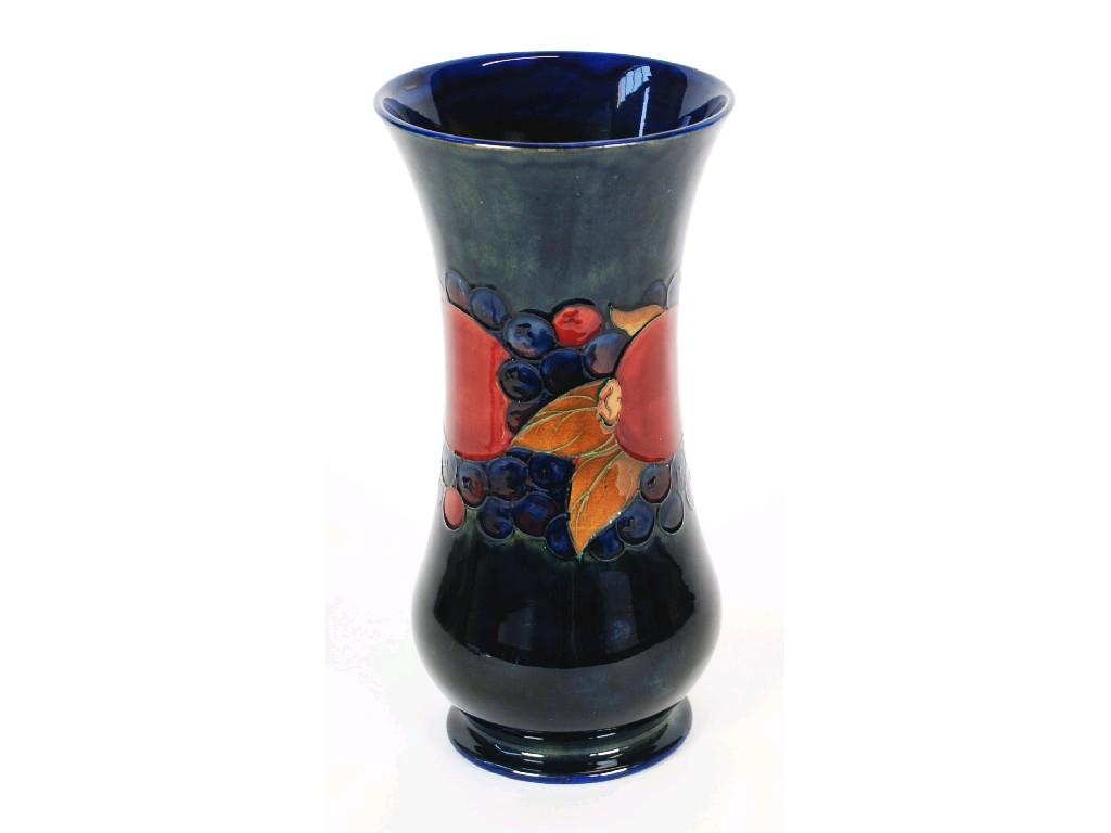 Appraisal: WILLIAM MOORCROFT POMEGRANATE PATTERN TUBE LINED POTTERY VASE footed waisted