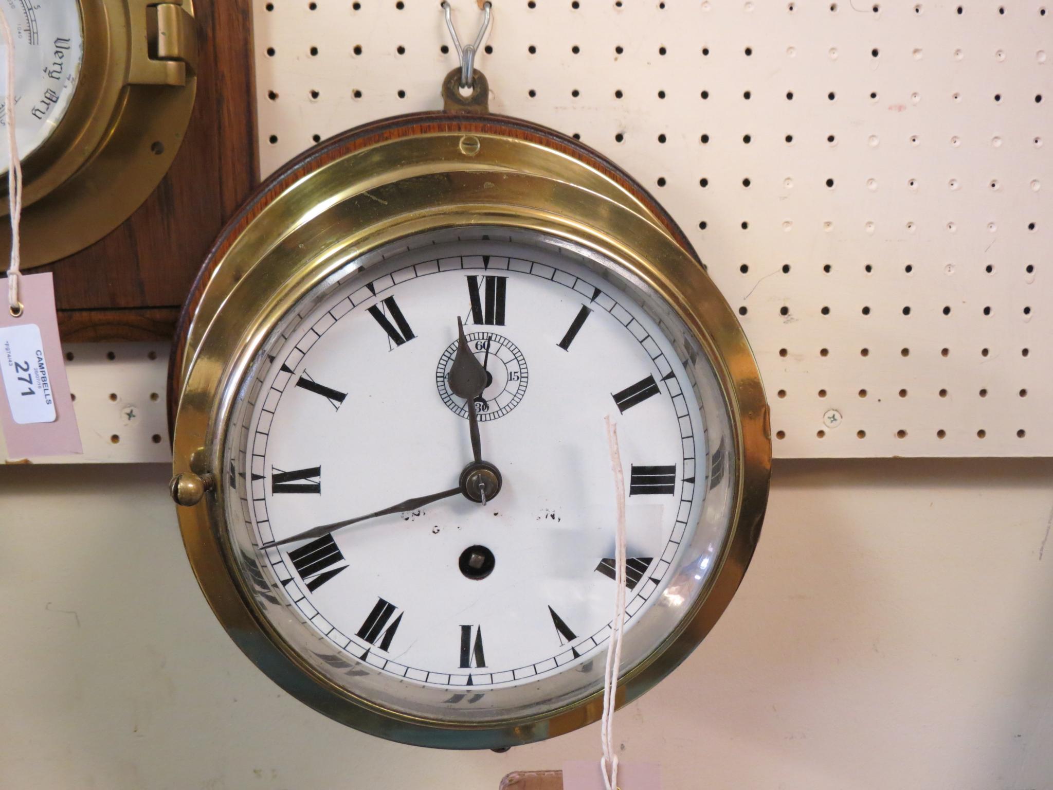 Appraisal: A ship's clock in enamelled dial with subsidiary seconds timepiece