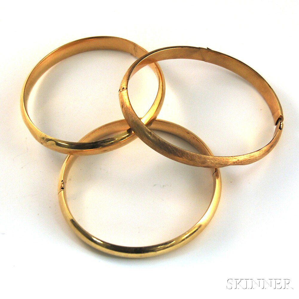 Appraisal: Three kt Gold Hinged Bangle Bracelets two polished and one