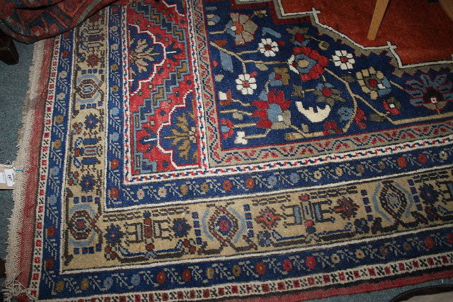 Appraisal: A TURKISH WOOLLEN TARPINAR KARYOLA RUG of rust and blue