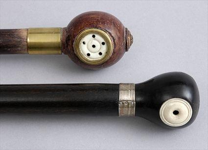 Appraisal: TWO WHISTLE-HANDLED EBONIZED WOOD CANES Each ivory-mounted wood handle with