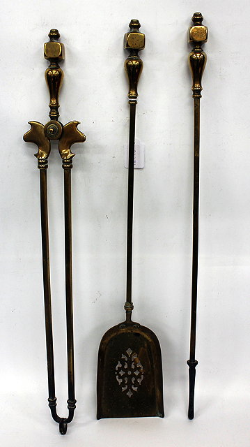 Appraisal: A SET OF THREE EDWARDIAN BRASS FIRE IRONS with pierced