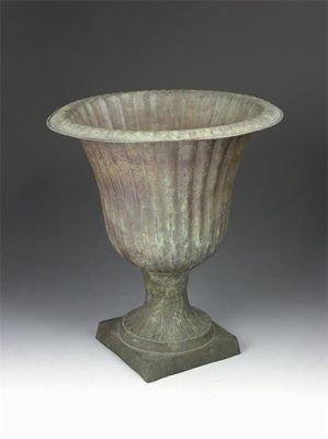 Appraisal: A patinated tin ribbed urn with a brass base in