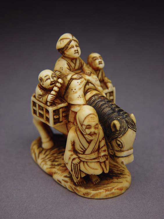 Appraisal: ANTIQUE IVORY NETSUKE Carved and stained antique ivory netsuke of